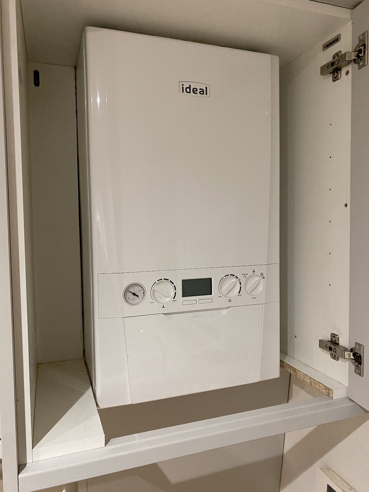 Ideal boiler neatly installed in a cupboard