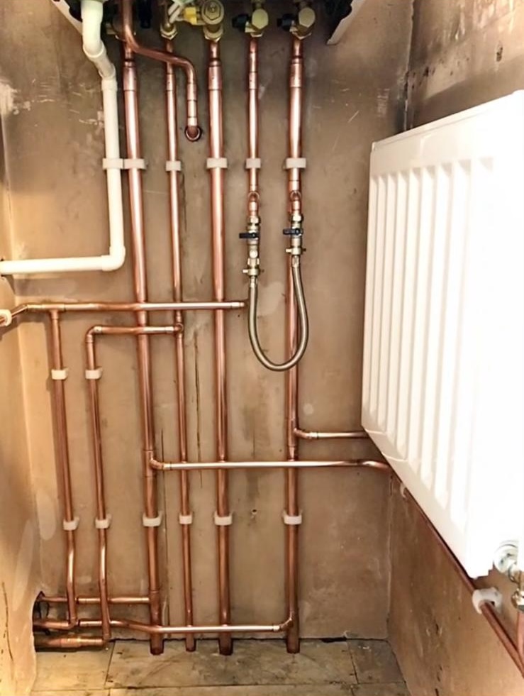 Copper pipework feeding a radiator